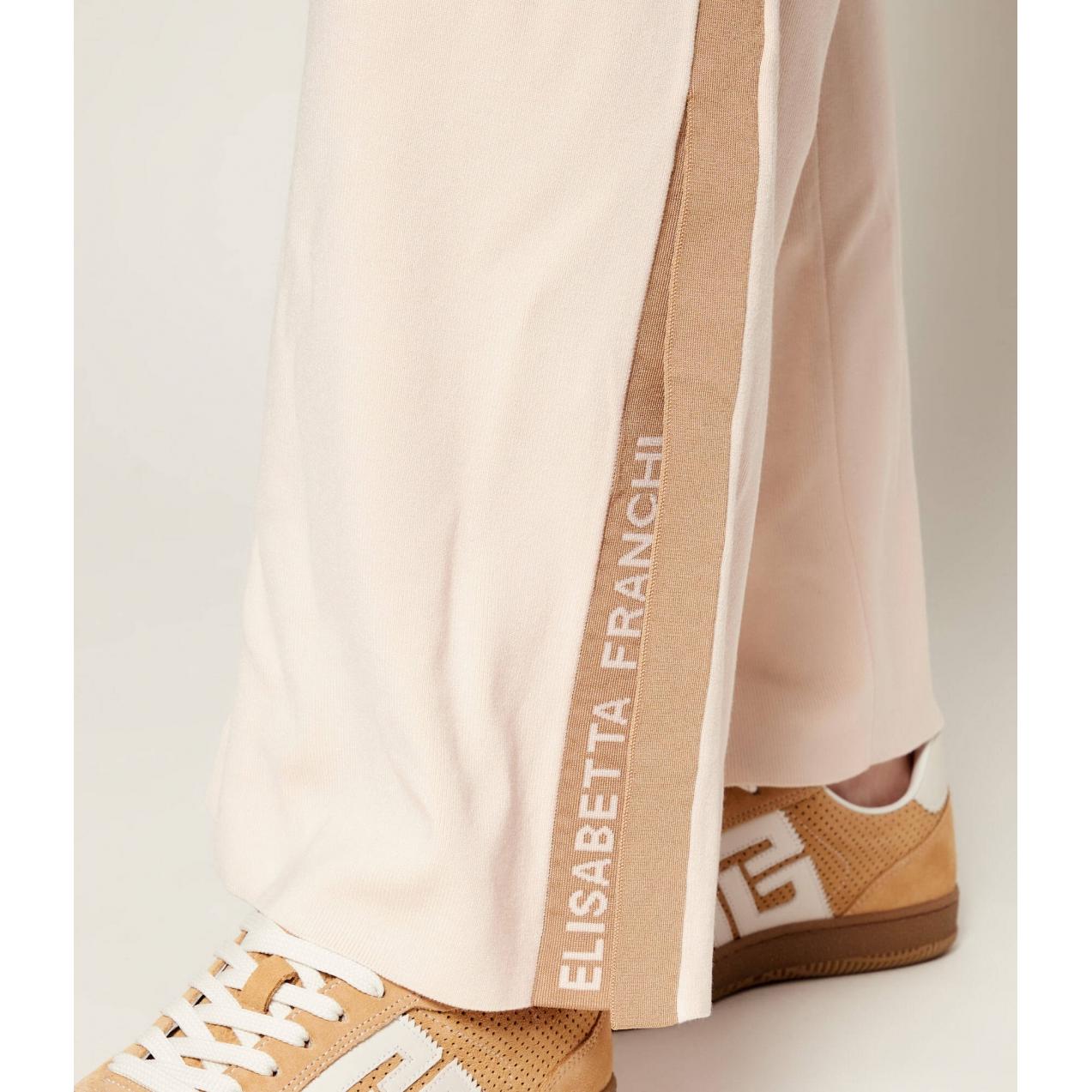 Tuta in maglia con bande in viscosa lucida