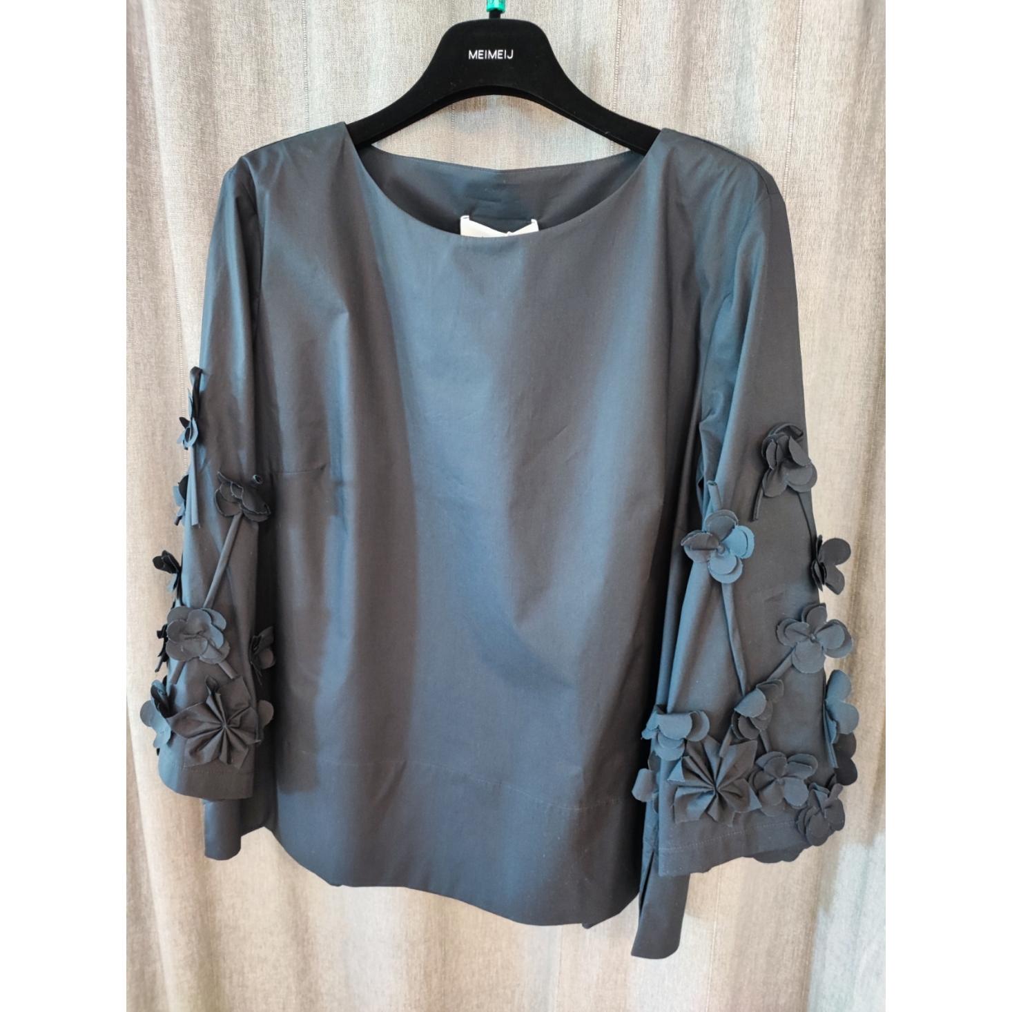 BLUSA CON APPLICAZIONI FLOREALI